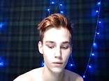 Cute boy with beautiful eyes strokes his cock