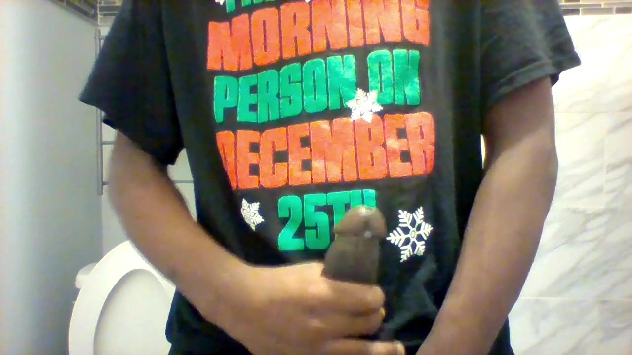 Black boy strokes his cock in toilet