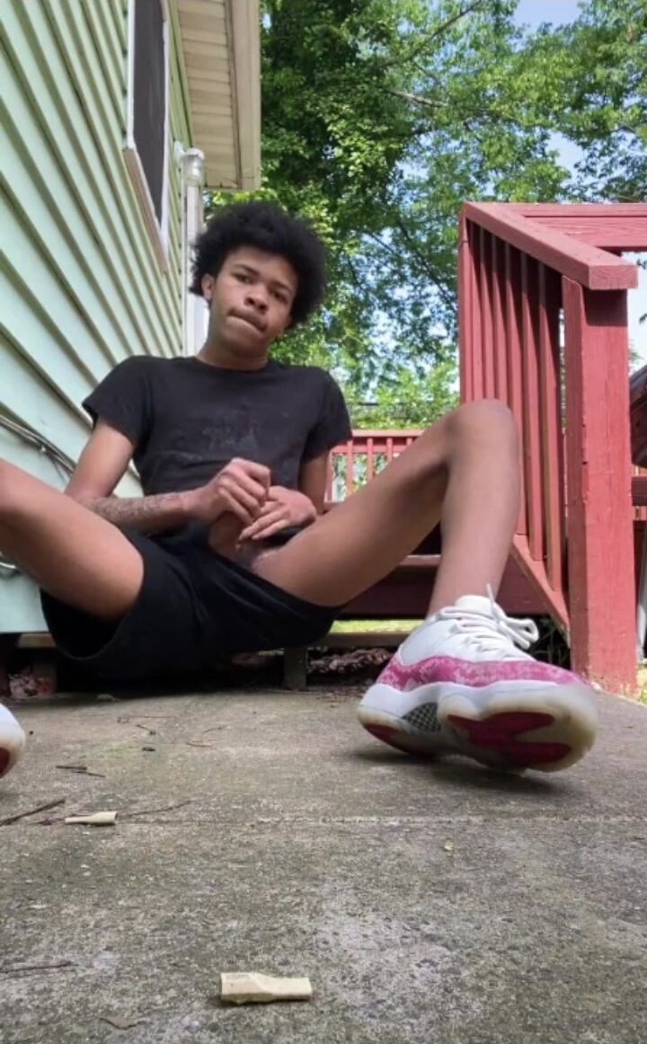 Black guy wanks outside and cums