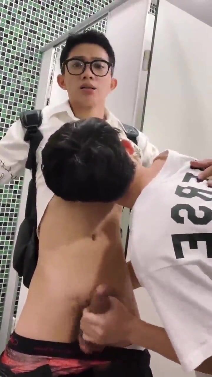 Voyeur catches asian twink getting helping hand in public toilet