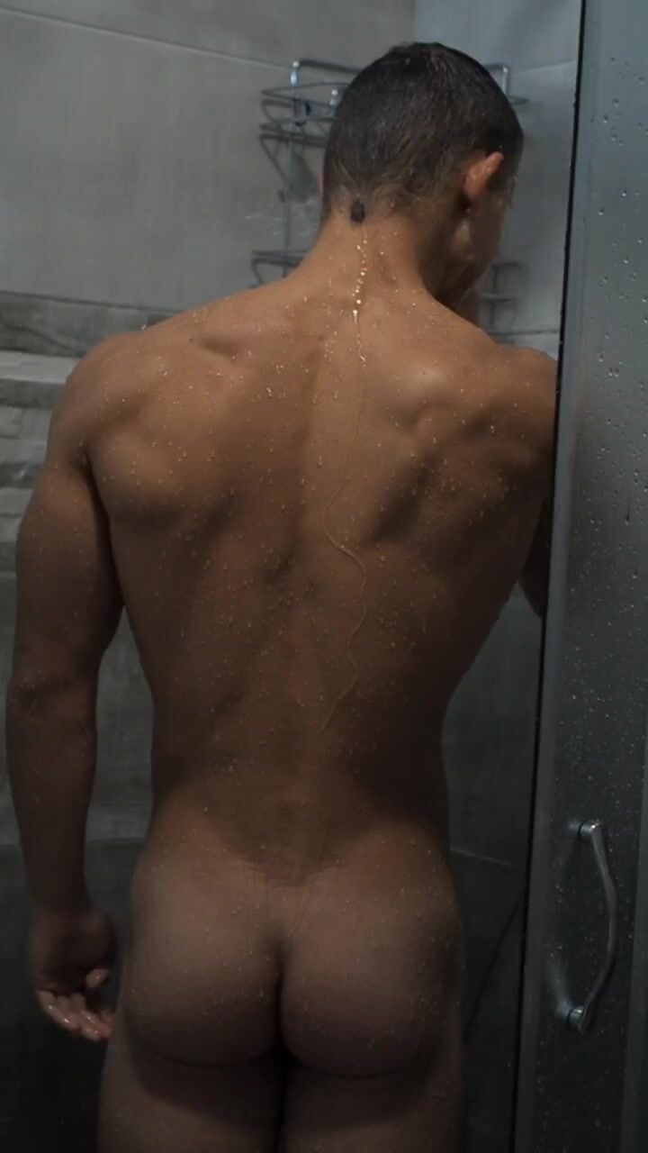 Muscle boy showering from behind