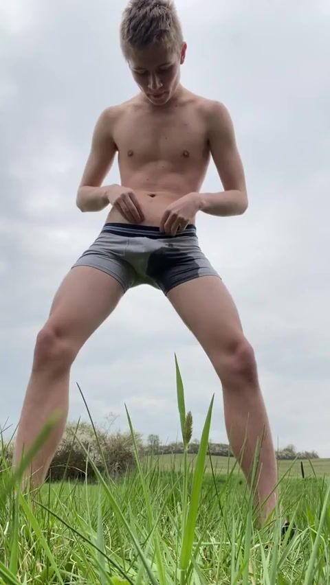 Blond twink pisses boxers outside