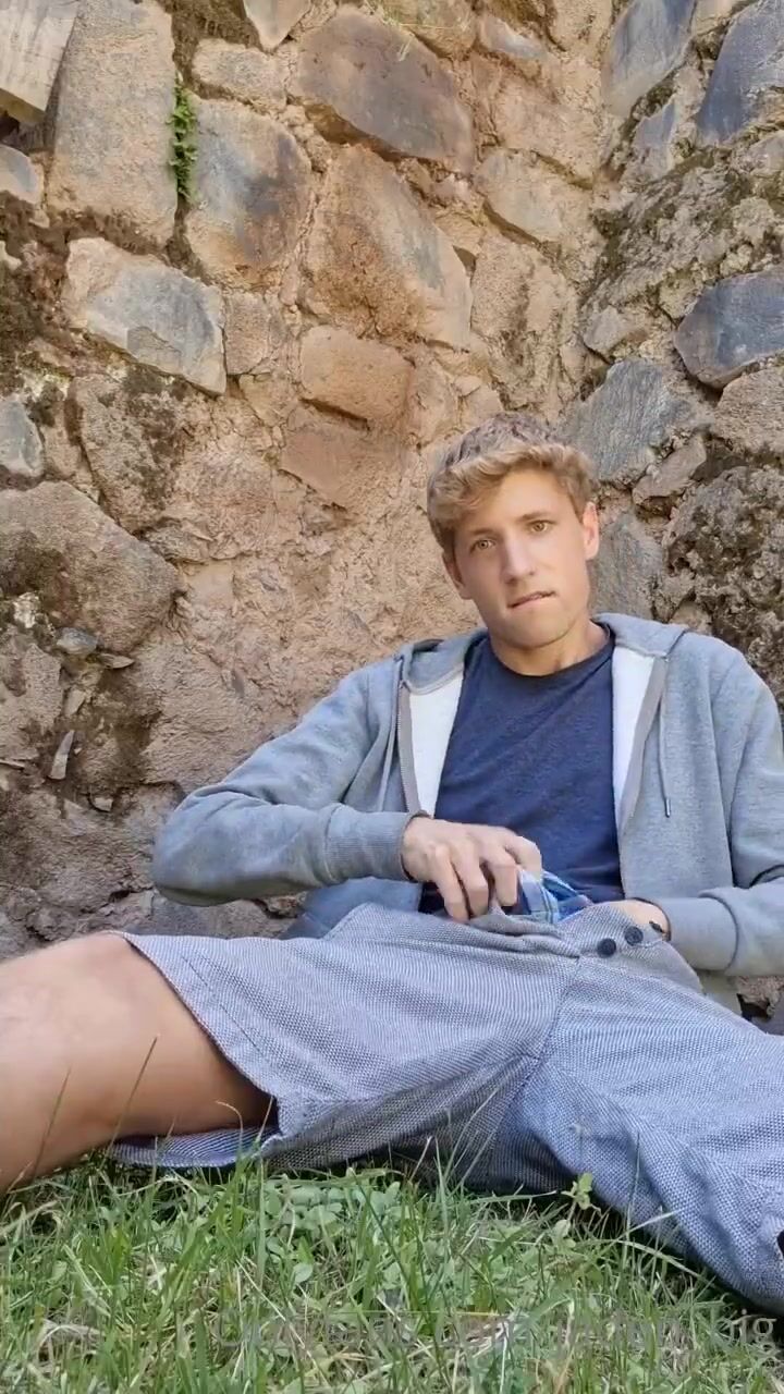 Blonde twink strokes cock outside