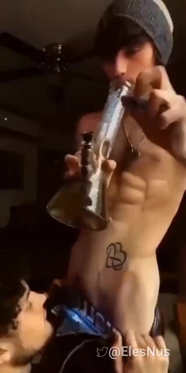 Blowing his bro's bong
