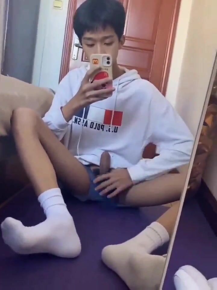 Boy playing alone in front of the mirror