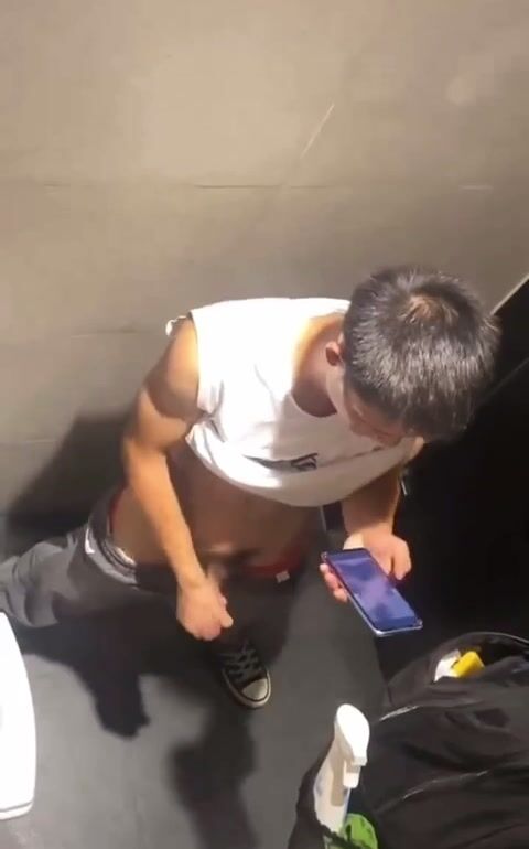 Chinese boy making a mess in a stall