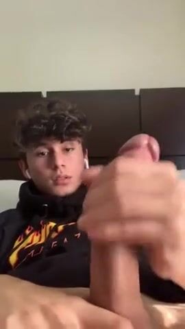 Clay in black hoodie strokes long cock on bed