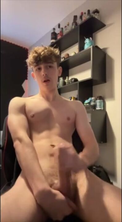 Curly blonde twink jerks off and cums on gamer chair