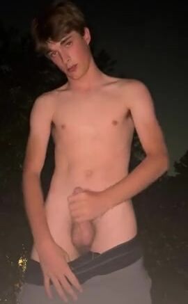 Cute fit blonde strips & strokes hard cock outside
