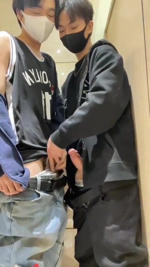 Sexy chinese boy in glasses masturbates with friend in public