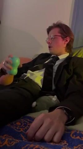 Suited gay dude jerks off and cums on cam