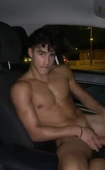 Jock jerks his cock in roadside car