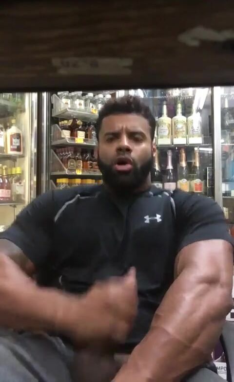 Horny muscle guy in liquor shop