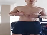 Muscled dude strokes uncut cock to nice load