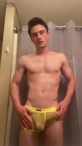 Jock strips yellow mesh to stroke his hard cock