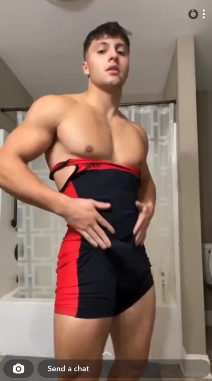 Jock wrestler strokes cock inside and outside singlet
