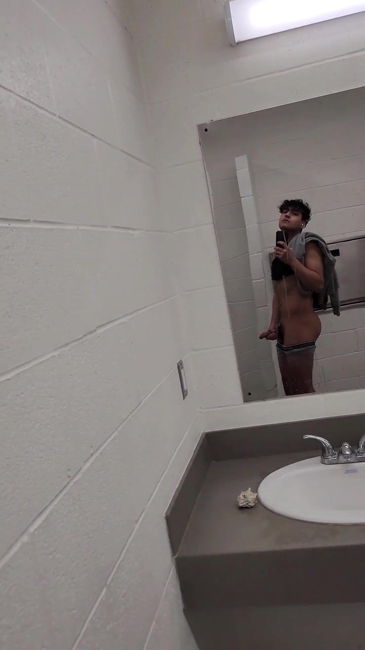 Latino twink jerks cock in public restroom bareback action