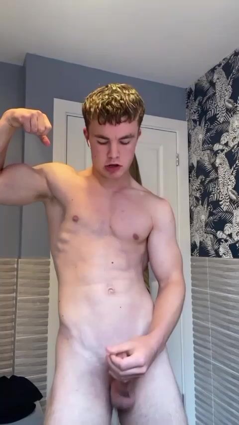 Muscular uncut stud shows off his cock