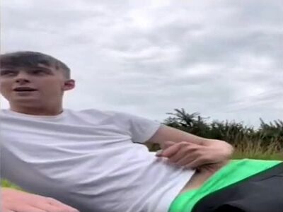 Twink strokes cock in field