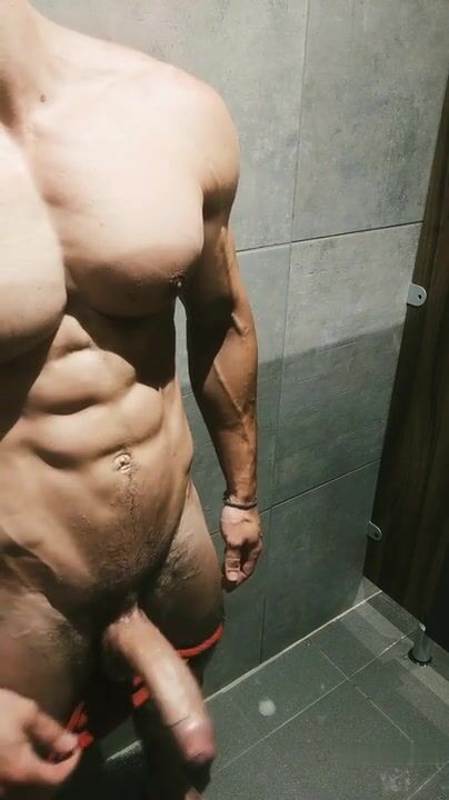 Shower hunk strokes big uncut cock