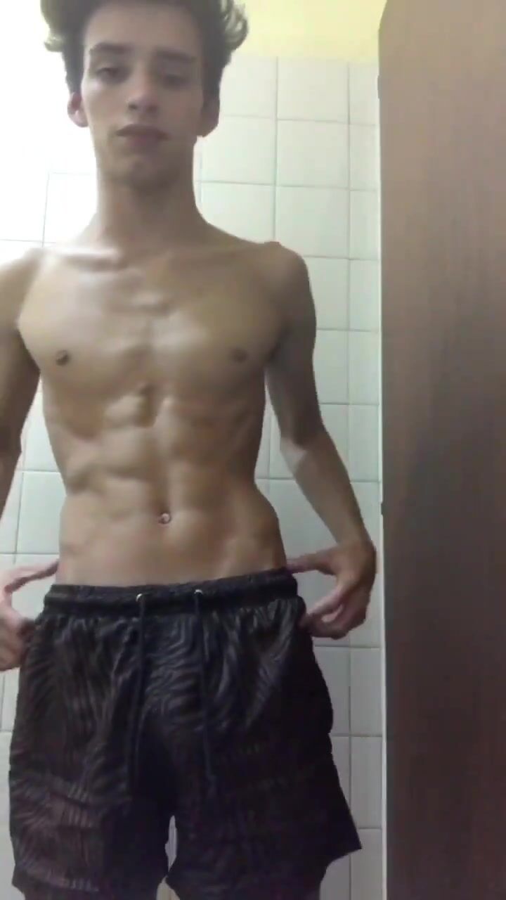 Smiling twink shows off his cock