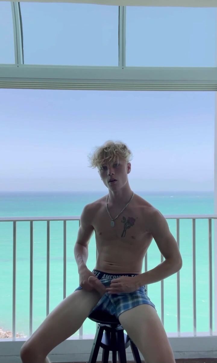 Skinny blond hunk masturbates on hotel balcony