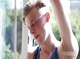Twink strokes cock by window