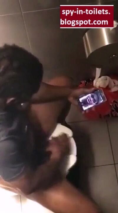 Spying black wanker shows big cock in toilet