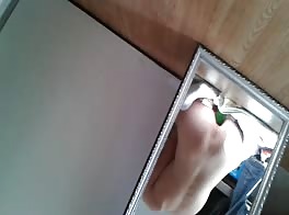 Teen having fun with a cucumber