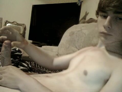 Teen strokes big uncut cock on couch