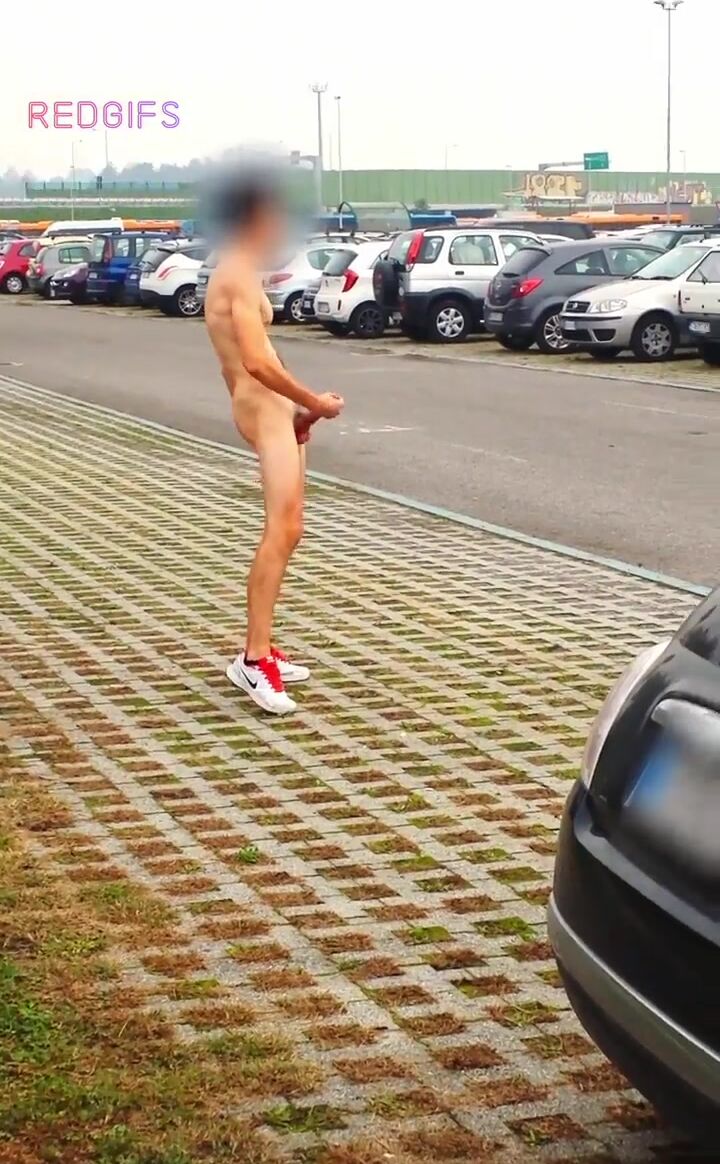 Twink jerks cock in public car park