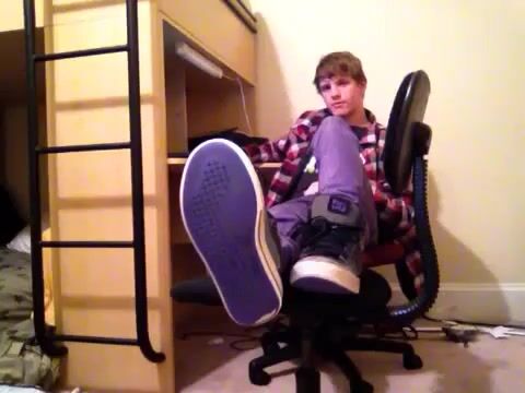 Cute twink takes off sneakers in chair