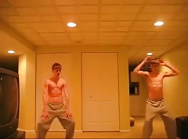 Twin dancers: one strokes his hard cock