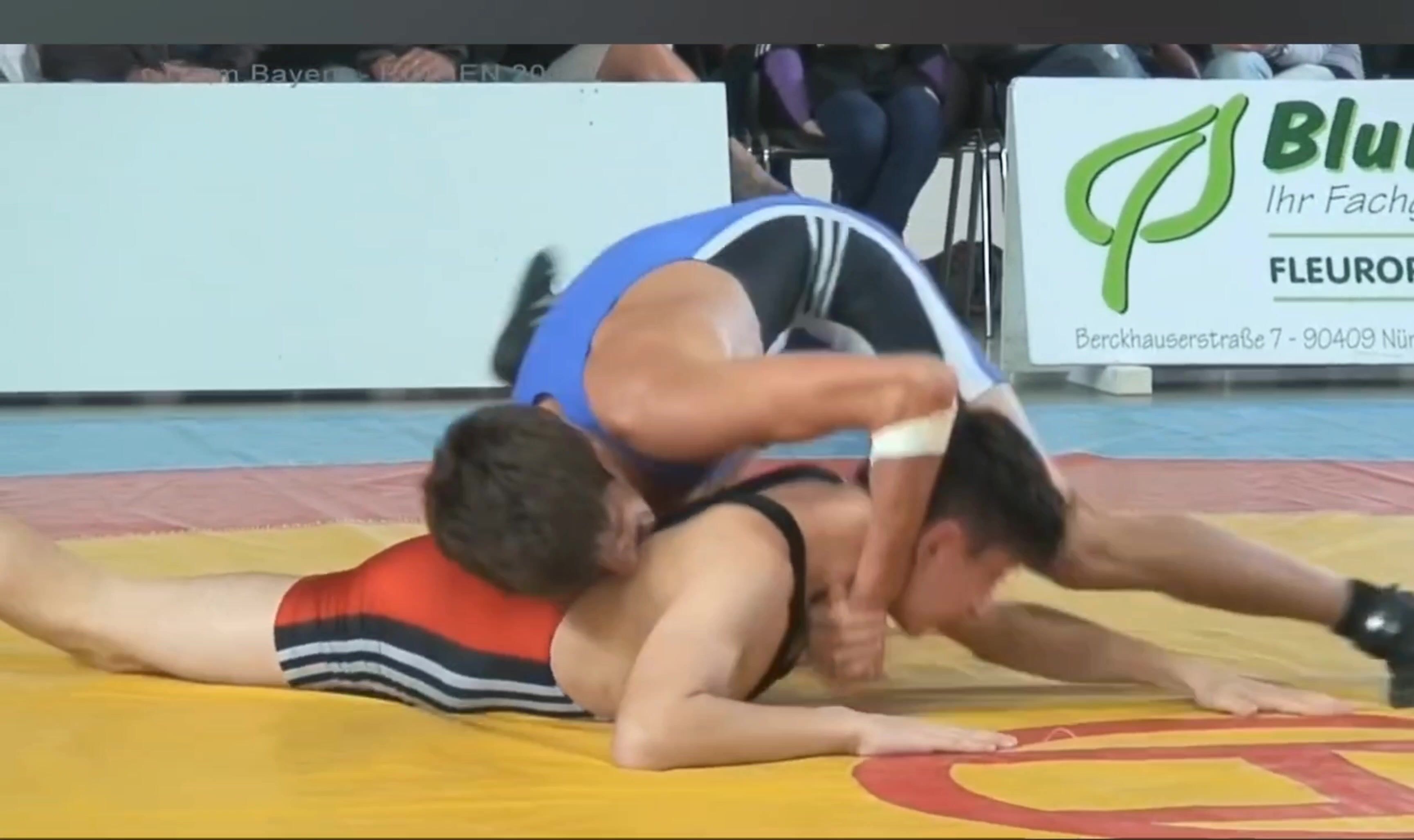Two boys in elastic swimsuits wrestling