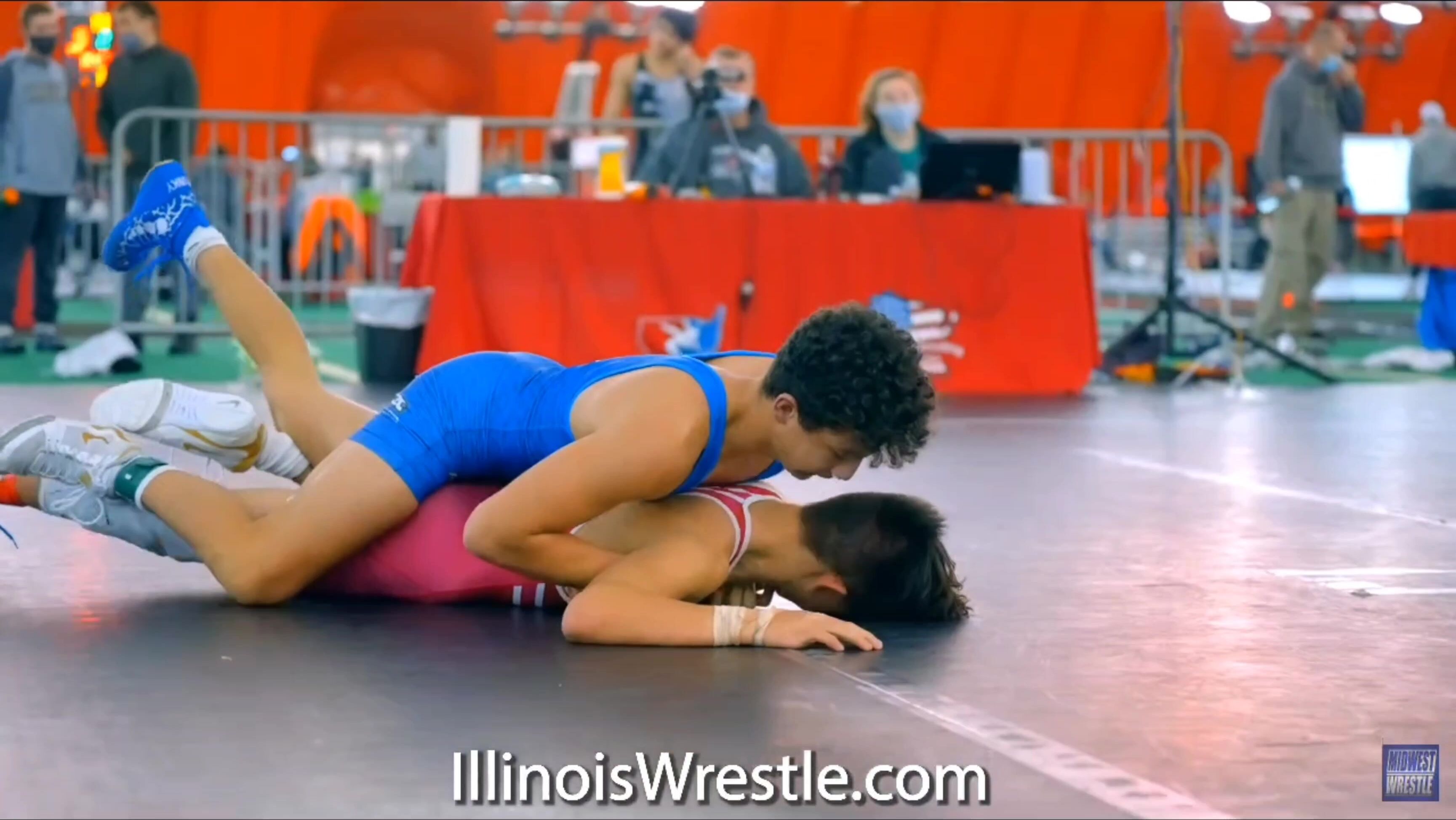 Two handsome boys wrestle in tight swimsuits