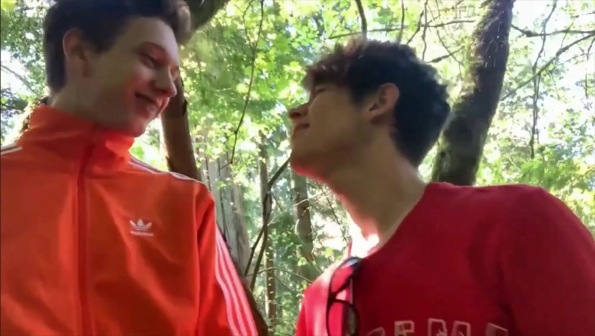 Two young soccer player fooling around and sucking each other in th...