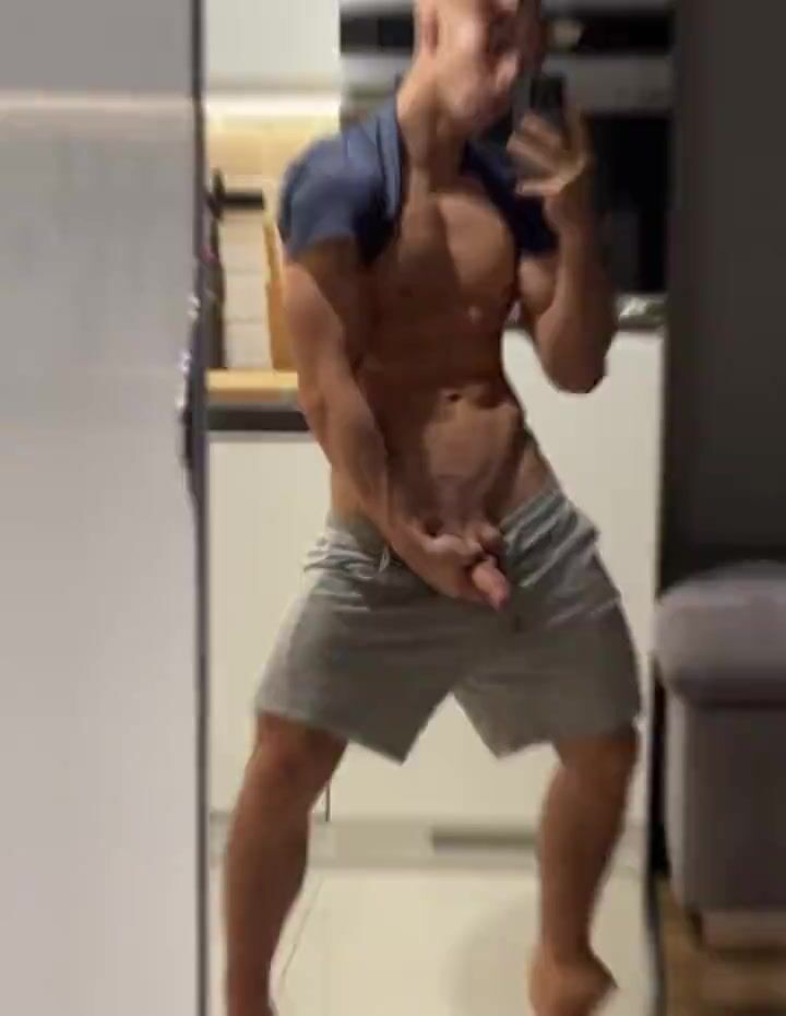 Uncut blond with six-pack poses in mirror porn