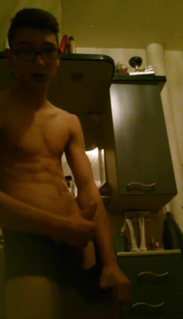 Uncut glasses twink strips and slowly strokes his cock