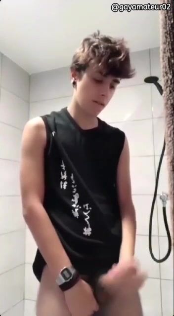 Uncut twink strips in the shower and jerks his hairy cock