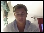 Smooth twink masturbates sensually on bed